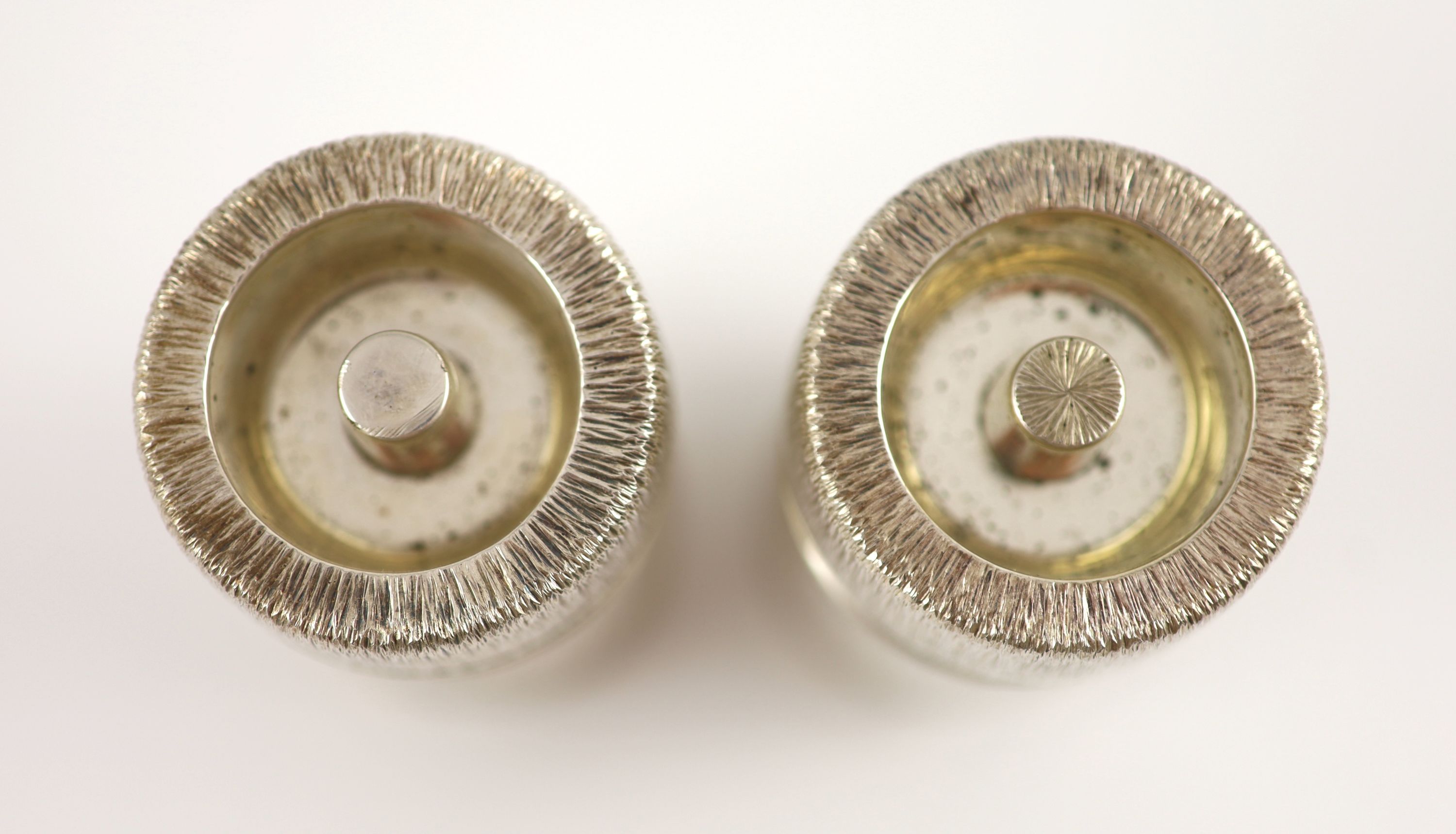 A pair of textured silver salt and pepper mills by Adrian Gerald Benney